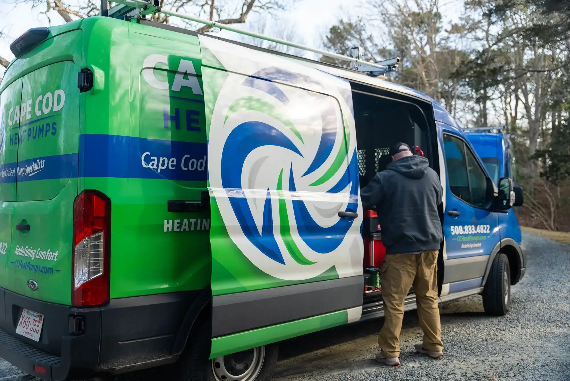 Tech getting supplies out of Cape Heating AC & Electric truck on Cape Cod, MA.