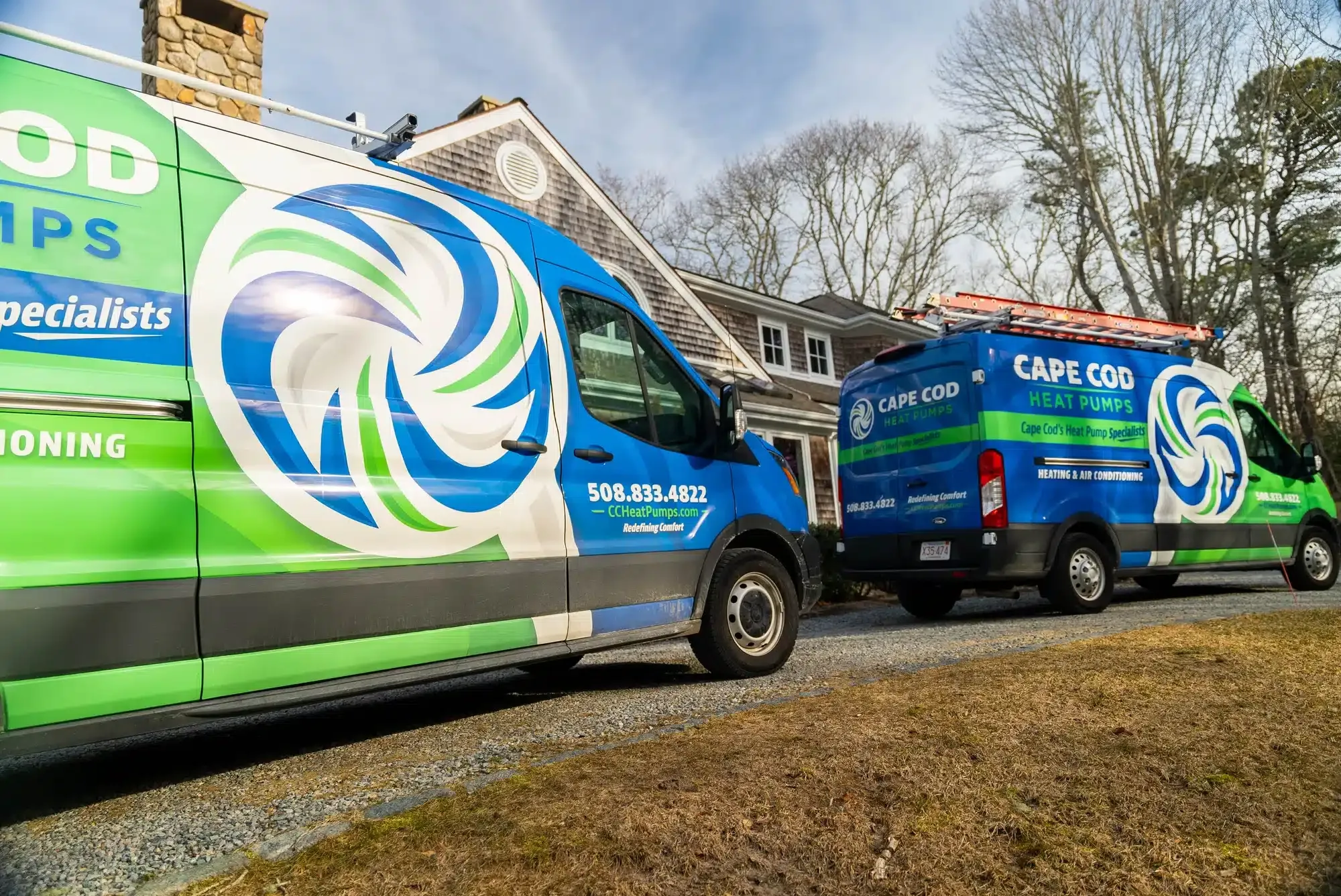 2 Cape Cod trucks outside of residential home on Cape Cod, MA.