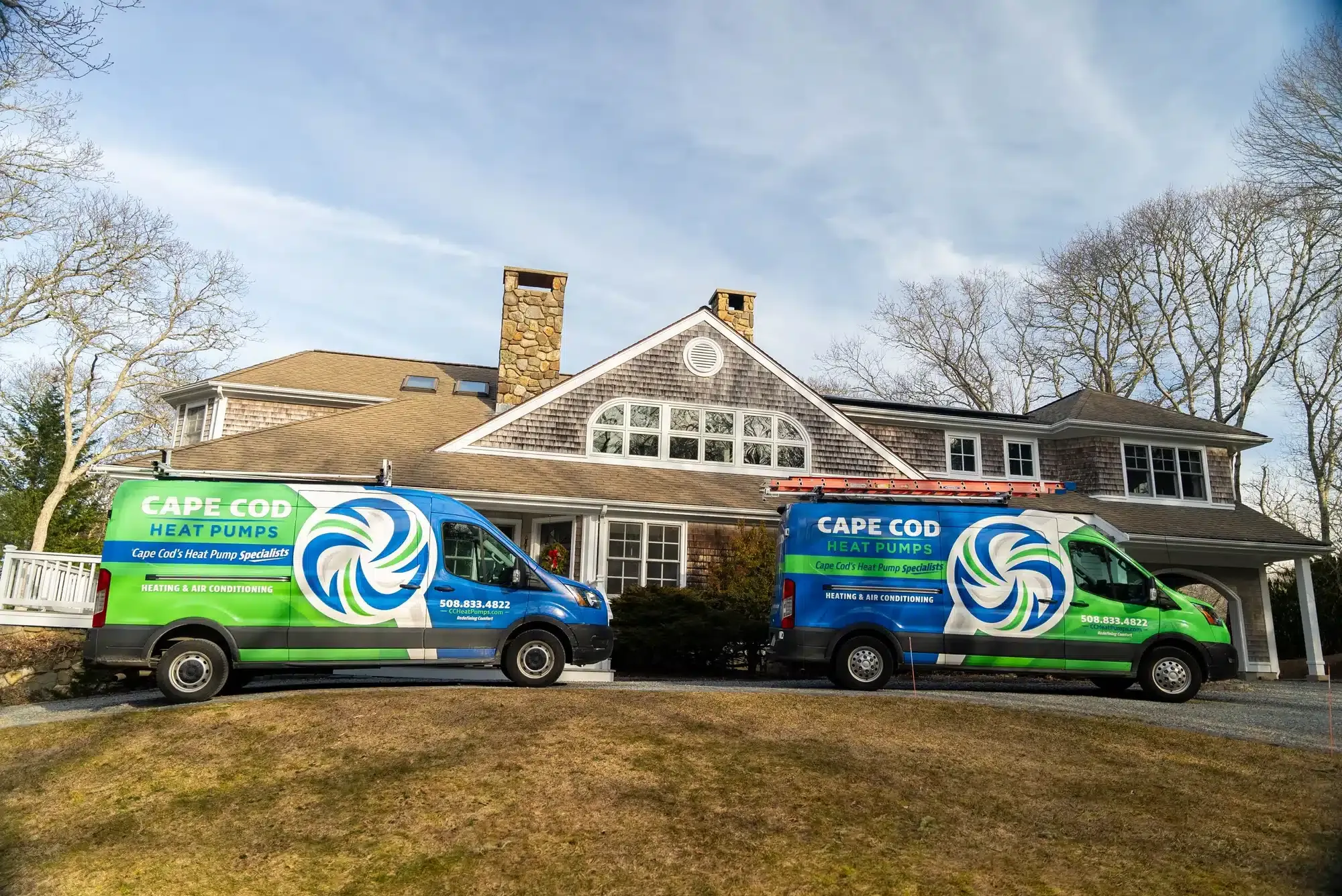 2 Cape Cod trucks outside of residential home on Cape Cod, MA.