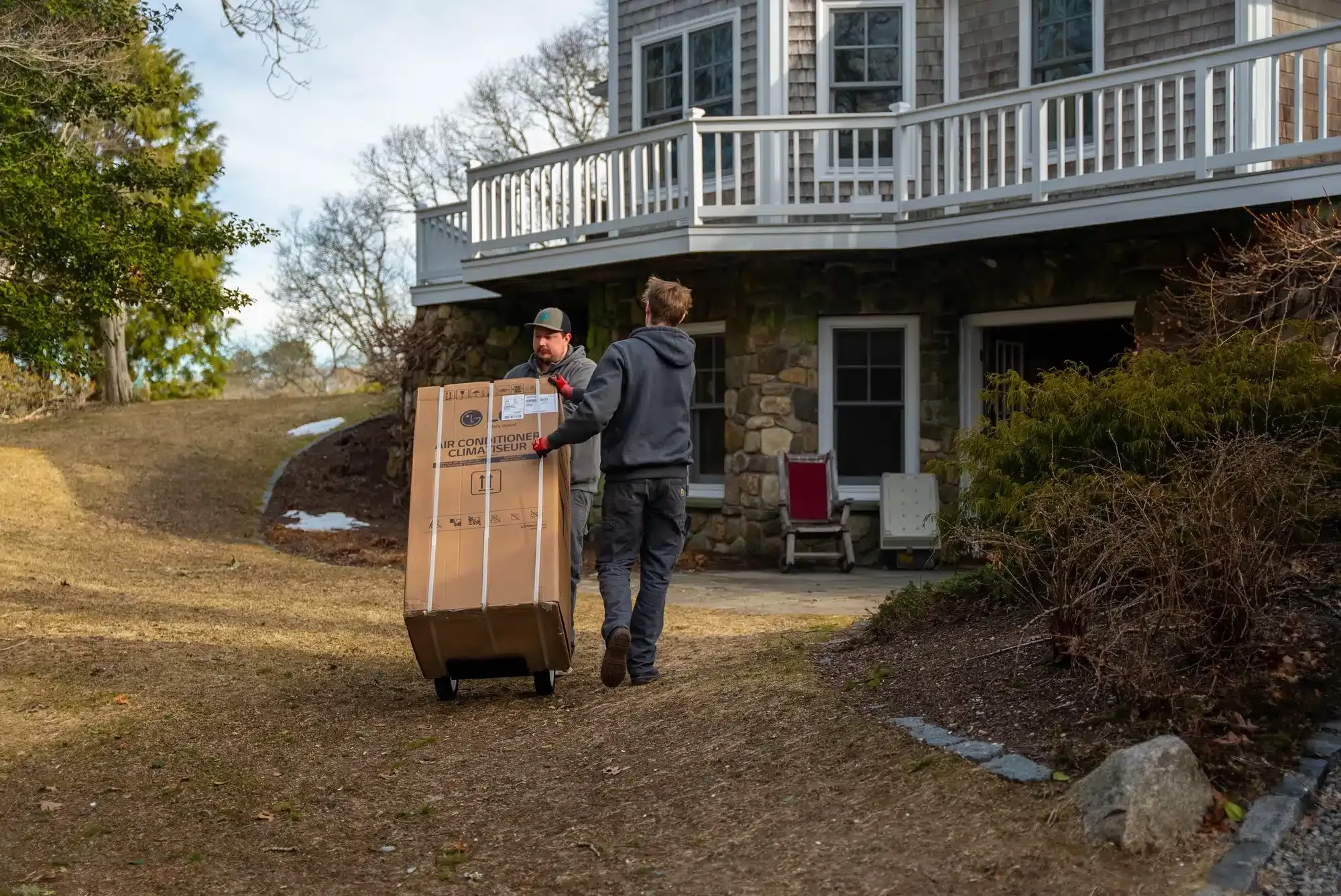 Cape Heating AC & Electric techs replacing air conditioner in residential home on Cape Cod, MA.