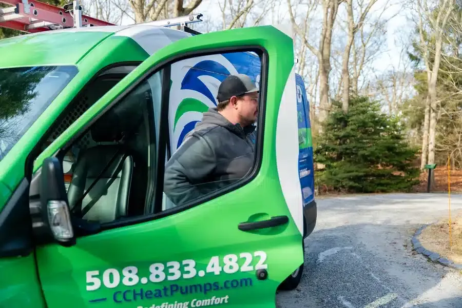 Cape Heating AC & Electric technician next to wrapped van on Cape Cod, MA.