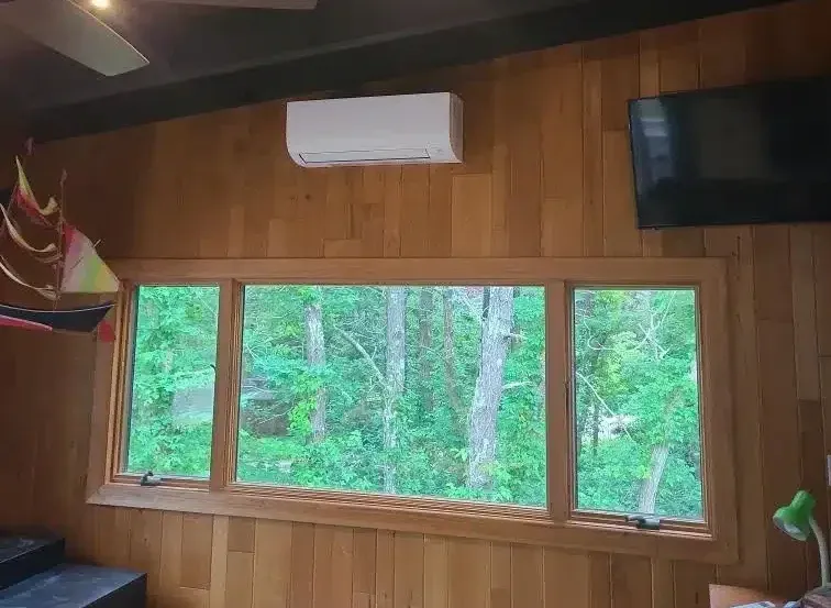 Indoor mini-split unit in a bright wood-paneled Cape Cod, MA family room