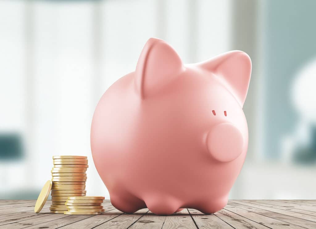 A pink piggy bank with gold coins, this represents the money that Cape Cod homeowners can save with HVAC rebates.