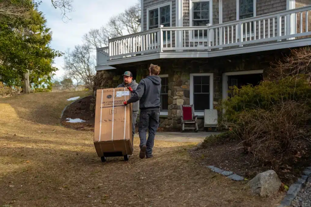 Cape Cod Heat Pumps techs replacing air conditioner in residential home in Cape Cod, MA.