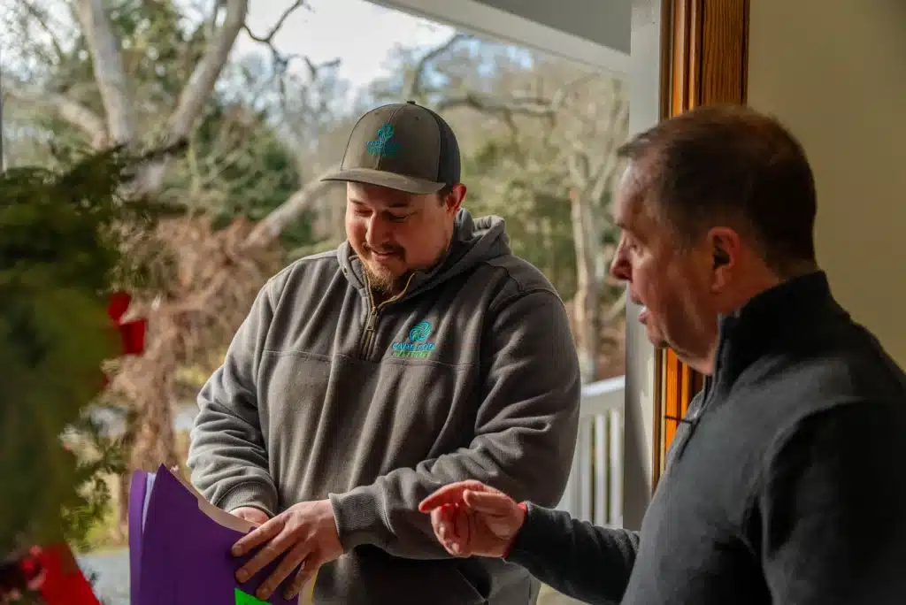 Cape Cod Heat Pumps tech helping customer in Cape Cod, MA.